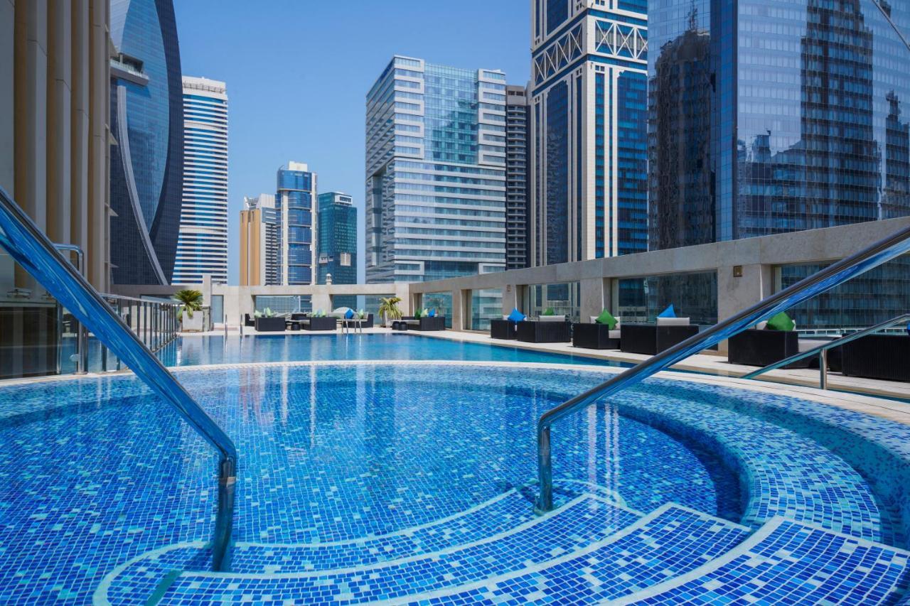 Wyndham Grand Doha West Bay Beach Exterior photo The swimming pool at the hotel