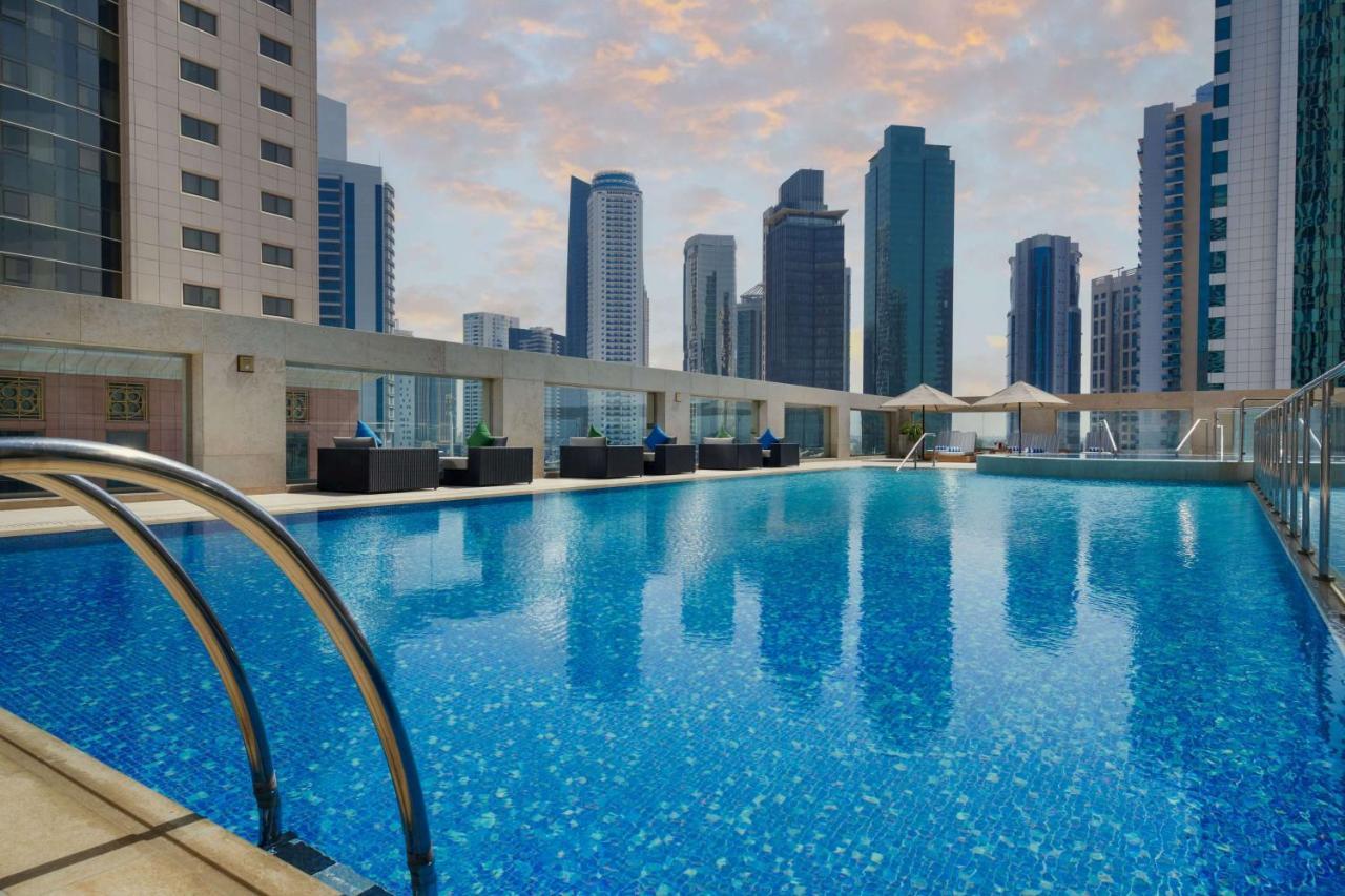 Wyndham Grand Doha West Bay Beach Exterior photo The swimming pool at the hotel